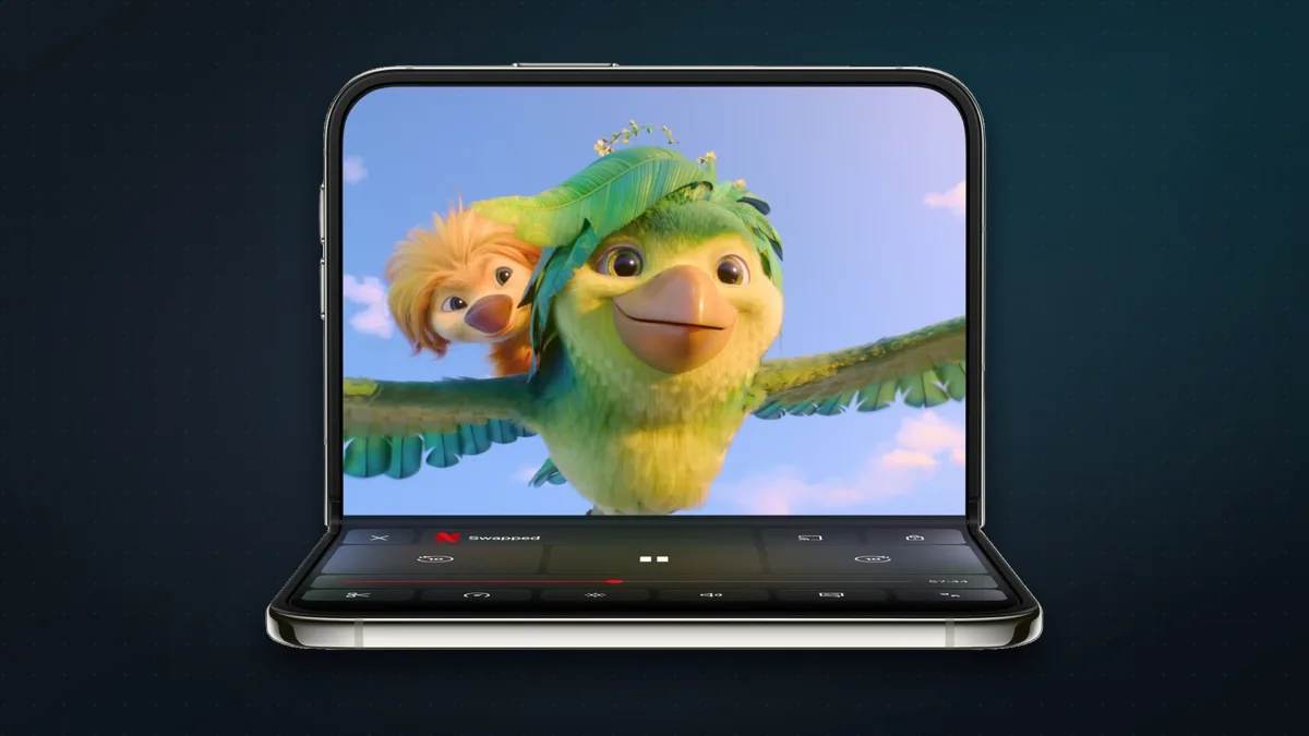 iPhone Duo half-folded like a laptop, with a Netflix film on the upper half and playback controls on the lower half