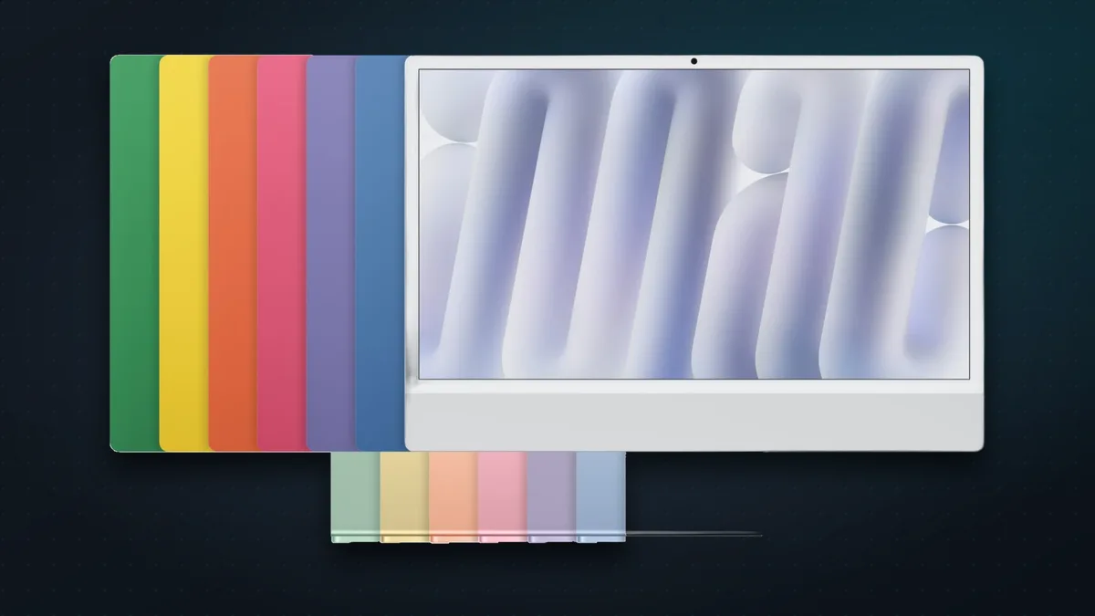 The seven iMac with M6 colours stacked behind a silver iMac