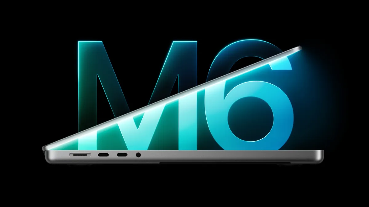 The M6 logo glowing above a partly open 14-inch MacBook Pro