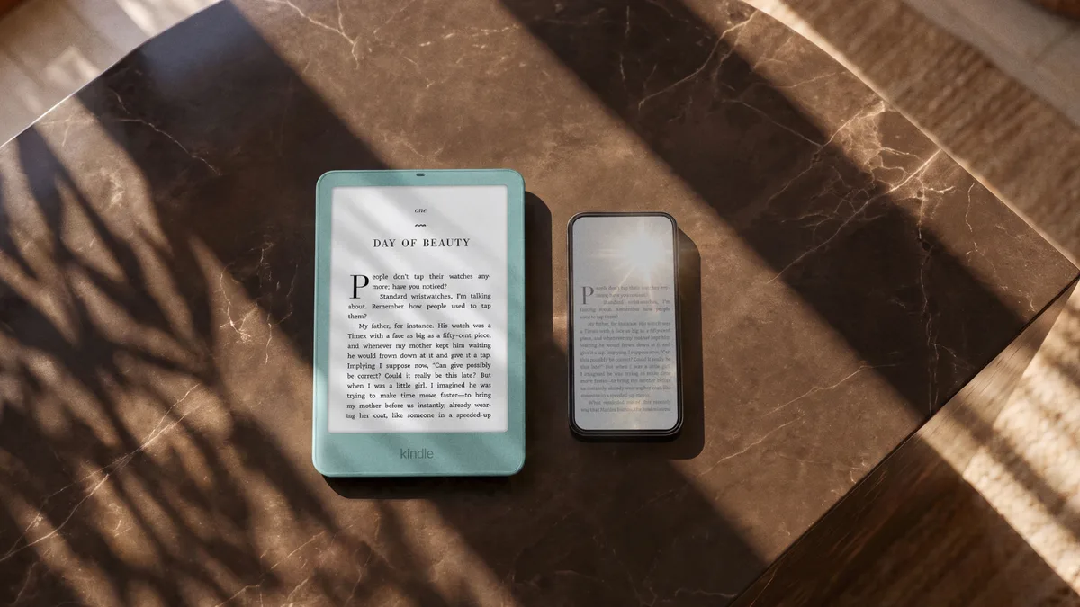 Kindle Paperwhite Signature Edition next to a smartphone on a marble table